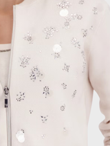 Elegant champagne beige jacket adorned with decorative jewelry accents, perfect for enhancing any outfit.