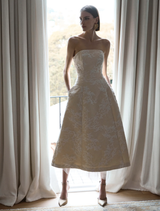 Elegant Madelein dress in champagne hue, featuring a graceful design suitable for special events and celebrations.