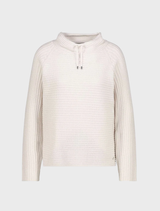 Monari's basic ribbed sweater in almond, offering a timeless style and comfortable wear for any occasion.