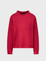 Stand-up collar top in chimney red, featuring a sleek design suitable for casual or professional wear.