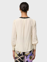Cloud-colored silk blouse featuring stylish pleated cuffs, perfect for a chic and polished look.