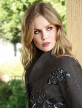  A gravel-colored Seam A Little Seam Jacket displayed on a hanger, showcasing its modern design and stylish silhouette.