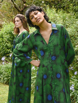 Green floral dress with a winter theme, featuring a fitted bodice and flowing skirt, perfect for seasonal occasions.