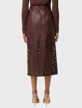 Oxblood leather midi skirt with a custom laser design, showcasing a sleek and stylish silhouette.