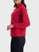 Stand-up collar top in a rich chimney red, combining comfort and style for everyday wear or special occasions.
