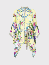 Silk blouse with a Chinoiserie floral design, featuring a collared neckline, batwing sleeves, and a removable belted waist.