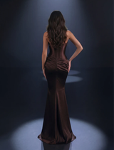 Glossy chocolate gown featuring a one-shoulder design, fitted bodice, side pleating, and a daring high leg split for elegance.