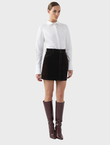 Stylish chocolate velvet mini skirt with a rich texture, suitable for various fashion styles and seasonal wear.