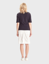 White Acrobat Legion Skirt laid flat, illustrating its shape and design features.