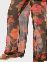 Brown dual trousers arranged neatly, emphasizing their style and color against a neutral background.

