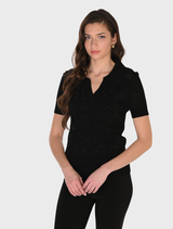 A black knit top laid flat, highlighting its fabric and style details.