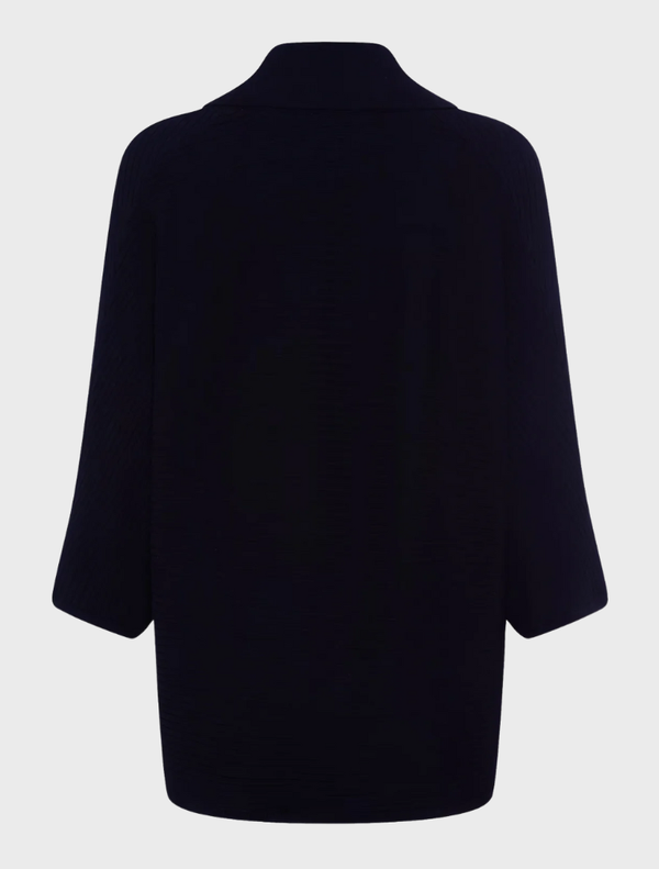 A black knit cardigan, highlighting its soft texture and classic style, set against a navy backdrop.
