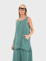 A green tank top on a white surface, illustrating its smooth texture and sleeveless silhouette.
