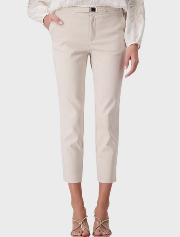  The model is dressed in a stylish white blouse and white pants, highlighting a clean and sophisticated look.