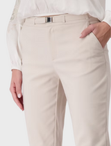 A model wears a crisp white blouse and tailored white pants, embodying a fresh and modern fashion aesthetic.
