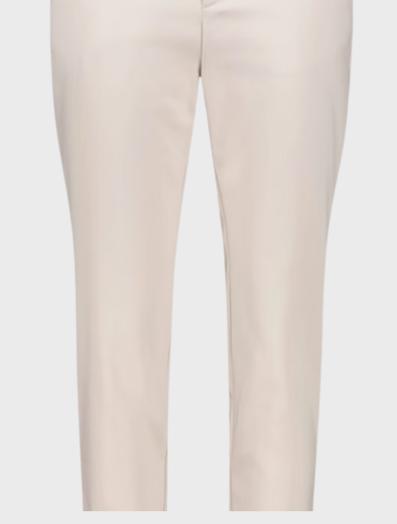The image features a model in a white blouse and white pants, exuding a polished and contemporary style.