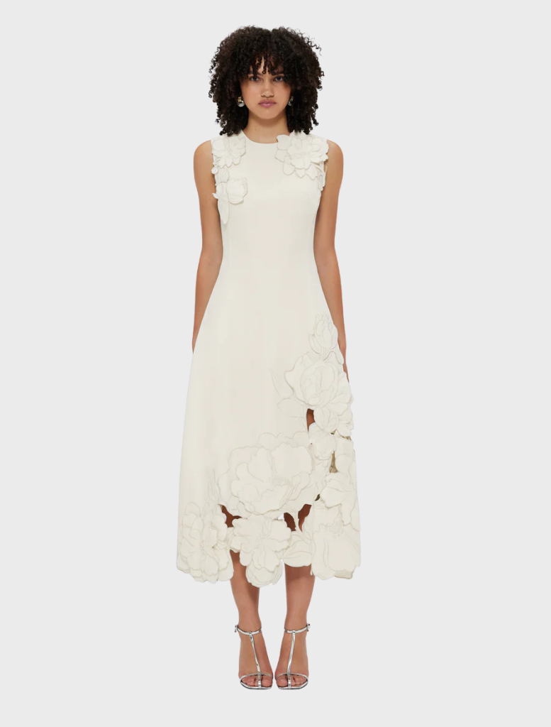 Sleeveless midi dress in vanilla with intricate appliqué detailing, perfect for warm weather occasions.