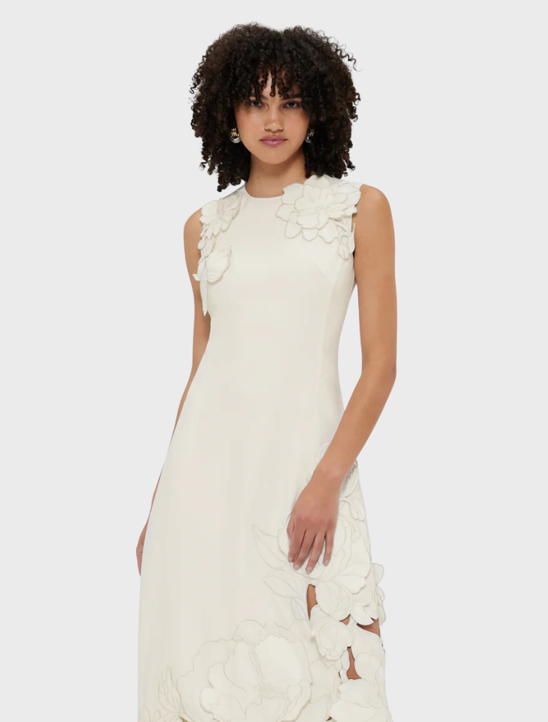 Feminine vanilla midi dress with a sleeveless cut and lovely appliqué embellishments, great for warm days.