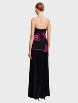 This dress features a black base with a vibrant pink swirl design, offering a chic and eye-catching appearance.