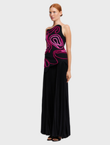 The dress is black with a pink swirl pattern, combining elegance and contemporary design elements.