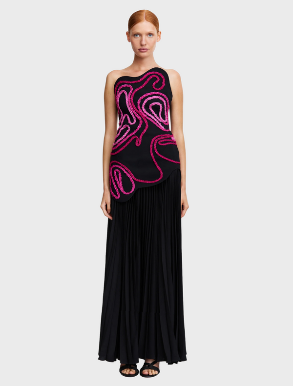  A black and pink dress featuring a swirling pink design, showcasing a stylish and modern aesthetic.