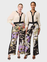 Cloud-colored silk blouse featuring pleated cuffs, perfect for a chic and refined look.