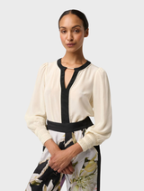 Soft cloud silk blouse with pleated cuffs, combining comfort and sophistication in a timeless design.
