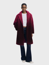 Ice cream pink coat displayed on a hanger, showcasing its soft fabric and stylish design.