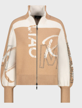 A cognac patterned cardigan jacket hanging, featuring a cozy design suitable for casual or semi-formal wear.