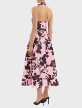 A stylish Connie Halter Midi Dress with a striking pink and black floral print, suitable for casual or formal events.