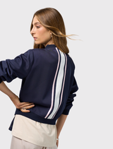 Bomber jacket in navy and white, featuring ribbed details, zip closure, and contrast tape accents on the back and pockets.