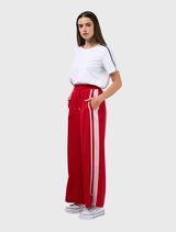 Poppy and blush wide leg pant featuring an elastic waist, flat front, adjustable ties, and contrast tape along the sides.