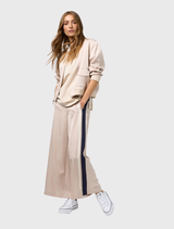 Stone and navy wide leg pant featuring an elastic waist, flat front, adjustable ties, and contrast tape along the sides.
