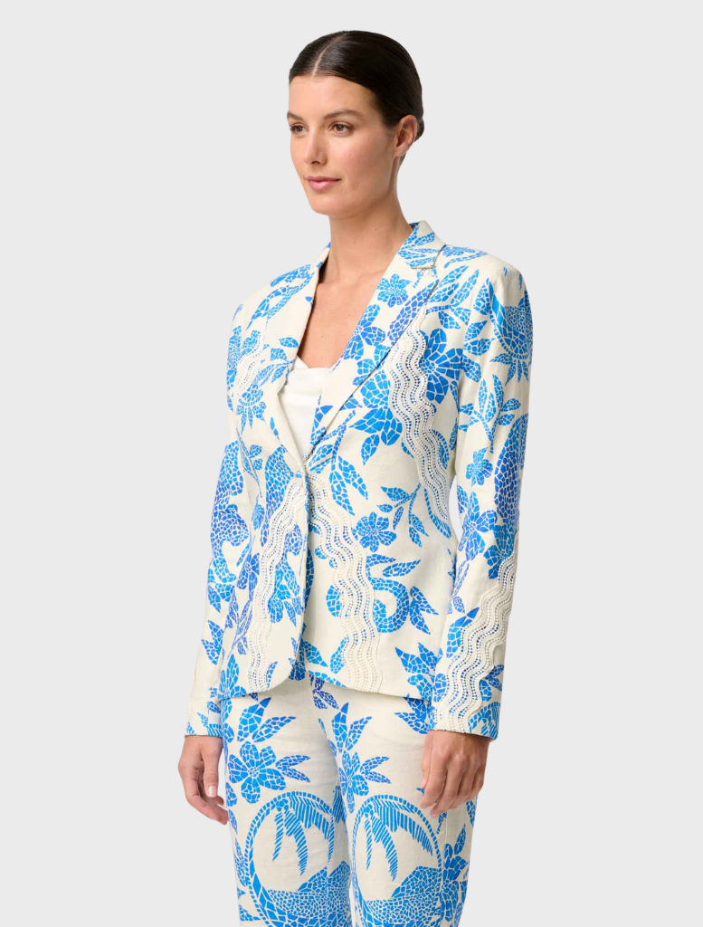 Model showcases a blue and white floral suit, featuring the Leandro Contrast Lace Linen Viscose Stretch Blazer in Azure Mosaic.