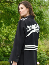 A black Cooper Club Jacket laid flat, highlighting its smooth fabric and minimalist design for a chic look.