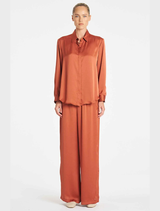 Copper-colored Maxi Pace Pant displayed on a white background, showcasing its sleek design and fabric texture.