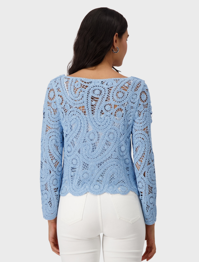  A beautiful blue crochet sweater displayed, showcasing its intricate design and craftsmanship.