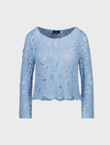 A stunning blue crochet sweater, highlighting its elegant texture and vibrant color.