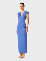 Talitha's cornflower blue dress with a plunging neckline, elegantly draped on a mannequin, highlighting its stylish design.