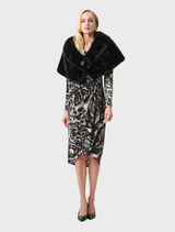 Black cover-up garment displayed on a neutral background, showcasing its sleek design and versatile style.