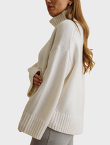 Elevate Mock Merino Cashmere Pullover in cream, hanging to reveal its smooth texture and sophisticated look.