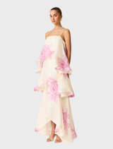 Tiered gown in cream and pink floral pattern, elegantly draped on a mannequin, highlighting its stylish design.