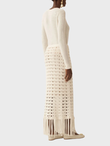 Off-white fringed knit skirt showcasing a soft texture, suitable for versatile styling options throughout the seasons.
