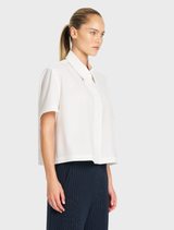 Minimalist Flex Weave Crop Shirt in Chalk, showcasing a smooth matte finish, classic collar, and button front design.