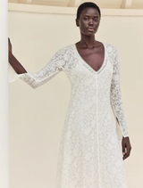 Sophisticated off-white lace dress with long sleeves and gathered flounce hem, ideal for special occasions and ceremonies.