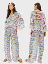 Vibrant Dahlia blouse with multicolor chevrons, floral designs, and "Music Is My Love" embroidery; includes bell sleeves and ruffled hem.