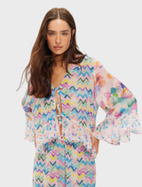Dahlia Ruffled Blouse in Fairy Dust, featuring multicolor chevrons, floral patterns, and "Music Is My Love" embroidery on the back.