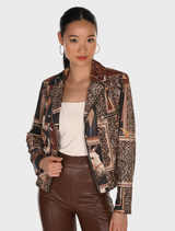 A woman models a leopard print jacket paired with leather pants, showcasing a stylish and bold fashion choice.