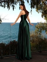 Close-up of a deep emerald gown, focusing on the intricate details and rich texture of the fabric.