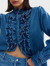 Close-up of the Luna blouse in denim, highlighting its unique stitching and color.